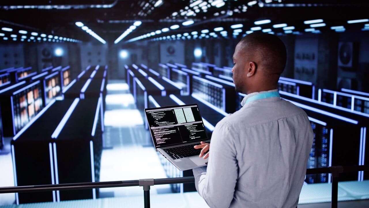 Smiling IT engineer in a data center